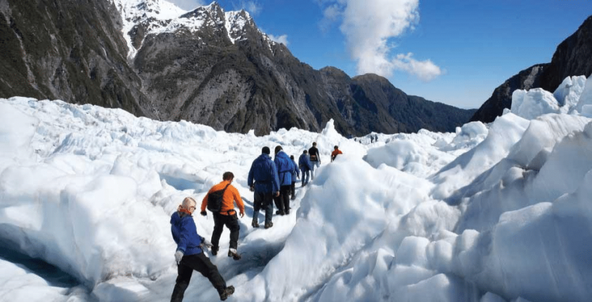 Group-of-people-walking-through-Franz-Josef-Glazier-New-Zealand-while-on-a-Gap-Year